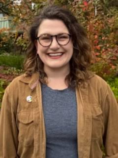 Image of white woman in tan jacket